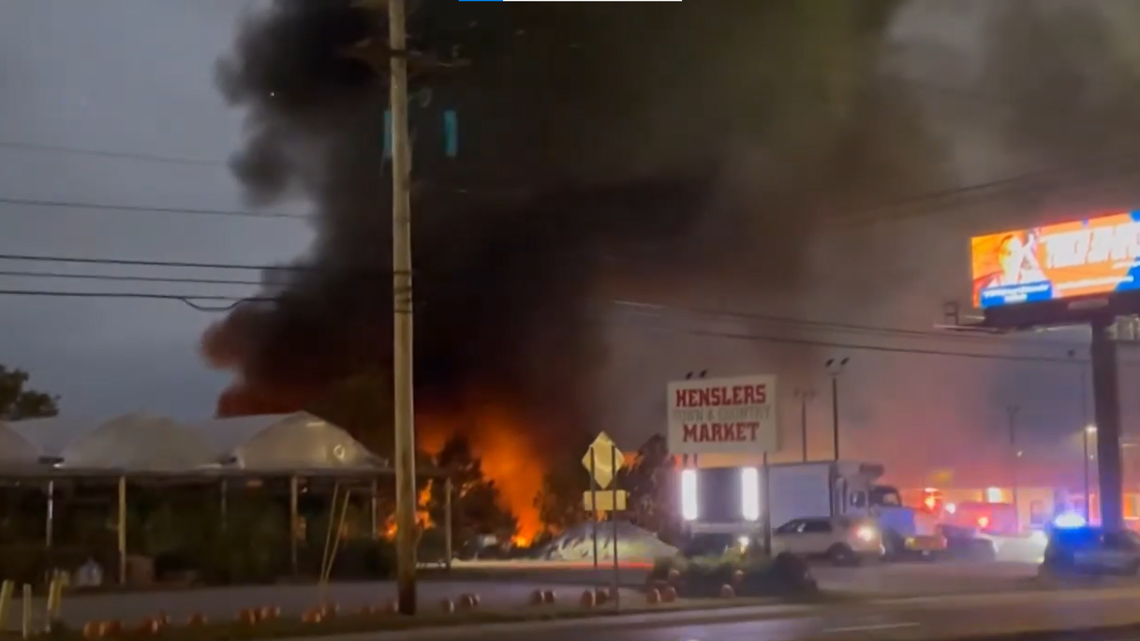 A plane crashed into a car dealership in Marietta, Ohio, killing the pilot and a passenger, police said. Video showed the fiery crash.