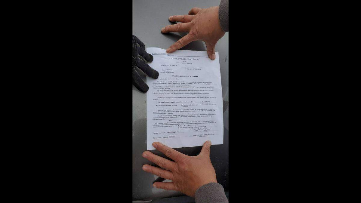 The suspects presented a fake warrant, pictured above.