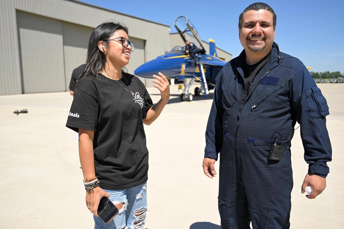 Student Stephanie Garcia-Rios, 17, greeted Erik Erazo, after his flight with the U.S. Navy Blue Angels.