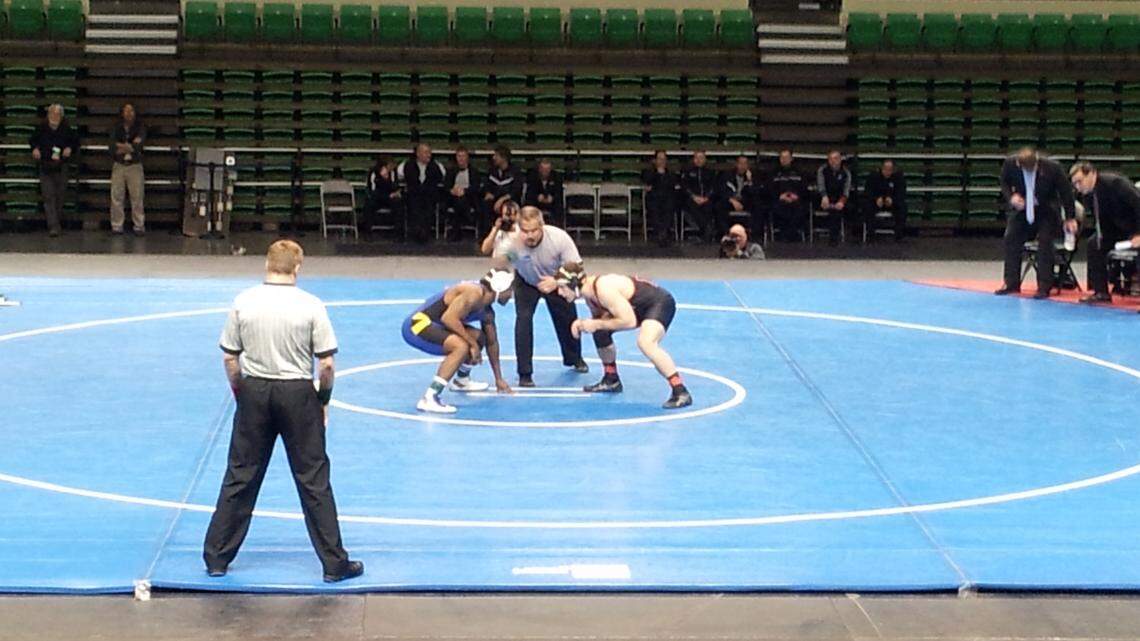 High school wrestlers prepare to start their match.