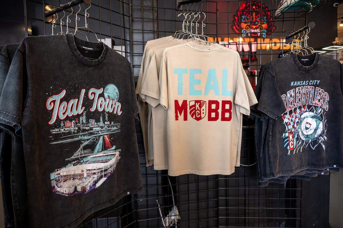 T-shirts featuring graphics created in collaboration between Made Mobb and the Kansas City Current are displayed on a racks at Made Mobb on Wednesday, March 18, 2026, in Kansas City.