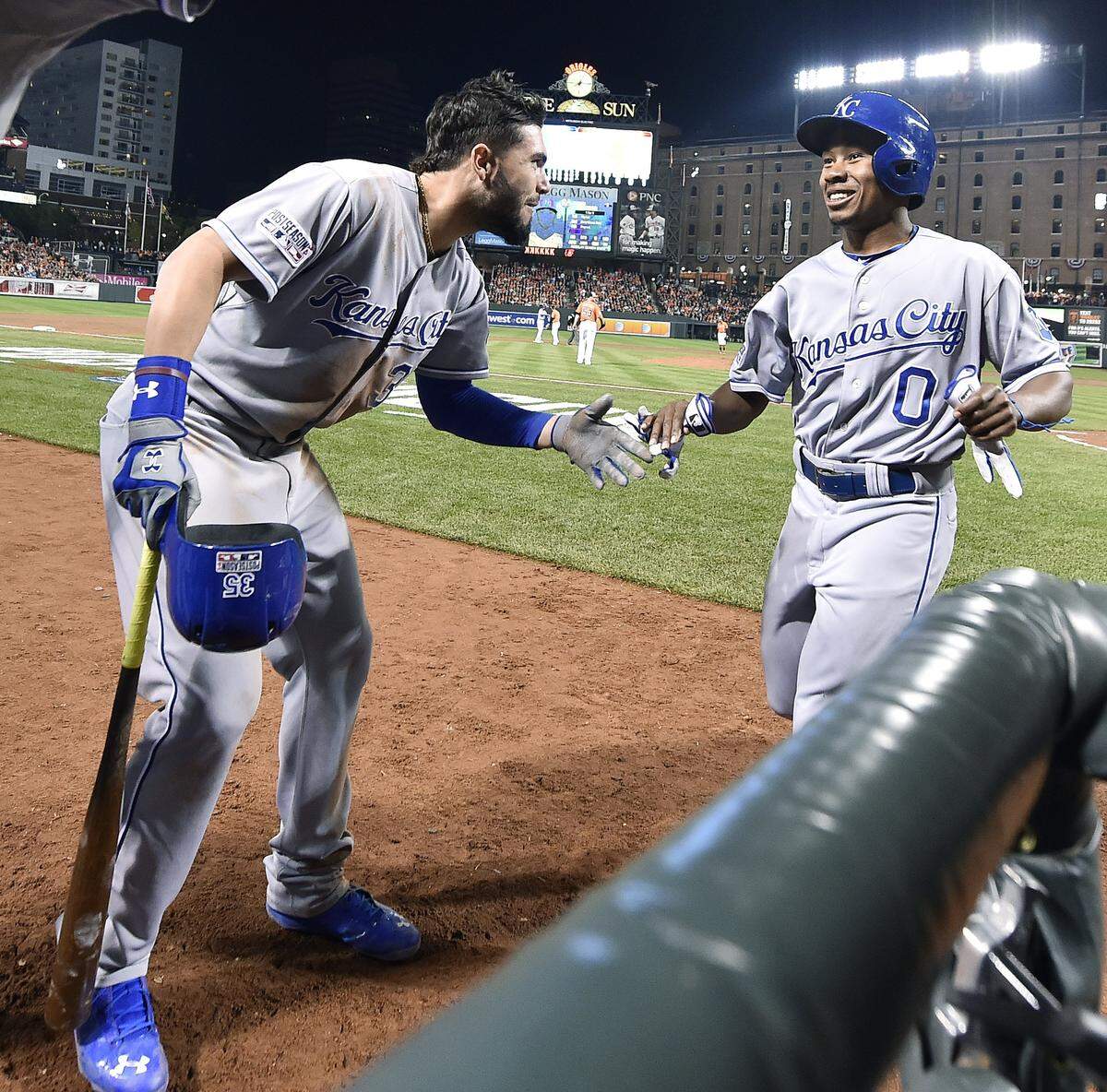 Kansas City Royals first baseman Eric Hosmer, left, congratulated Terrance Gore after Gore scored on a double by Alcides Escobar for the go-ahead run in the ninth inning of an ALCS game against the Orioles at Camden Yards in Baltimore, Maryland on Oct. 11, 2014.