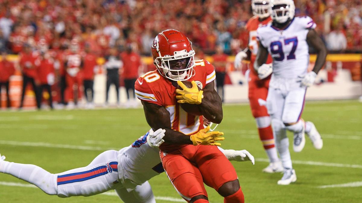 Kansas City Chiefs wide receiver Tyreek Hill fights for yardage in the first quarter while in the grasp of a Buffalo Bills defender Sunday, October 10, 2021, at Arrowhead Stadium.