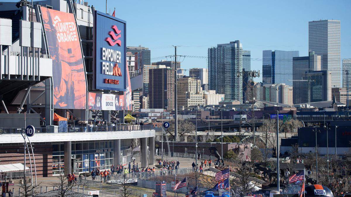 Fans arrive prior to an NFL football game between the Cincinnati Bengals and the Denver Broncos, Sunday, Dec. 19, 2021, in Denver. (AP Photo/David Zalubowski)