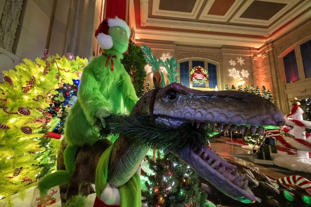 The Grinch rode a decked-out dinosaur, which is one of the displays at the “Holiday Reflections” display at Union Station on Thursday, November 20, 2025, in Kansas City.