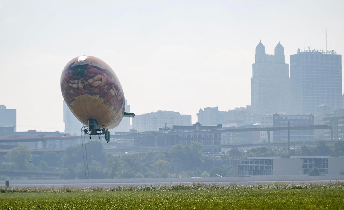 The Subway blimp lands in a grassy field just south of Kansas City’s Charles B. Wheeler Downtown Airport on Wednesday.
