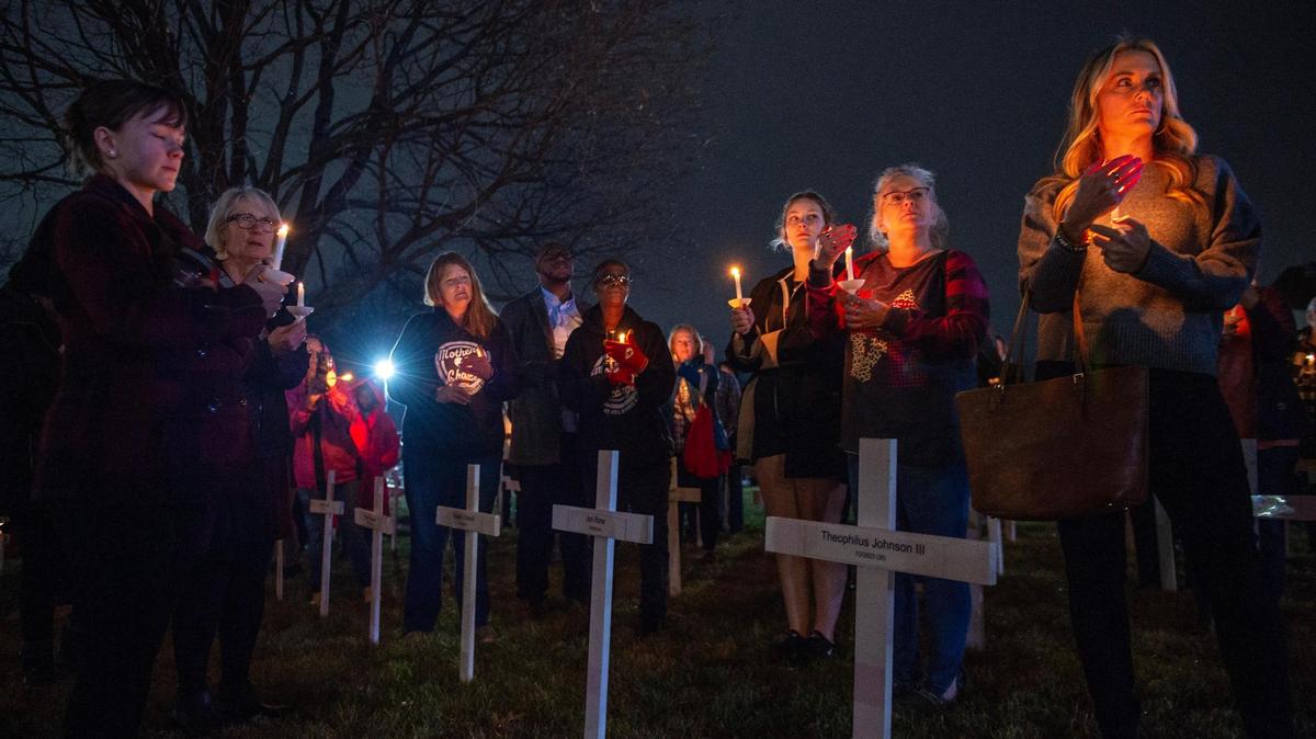 Community members hold a vigil on the front lawn of The Gathering Church on Thursday, Dec. 21, 2023, in Independence, Missouri, to honor the lives of homicide victims in Kansas City in 2023. Attendees united to read the names of these individuals, reflect on their legacies and offer support to those grieving the loss of their loved ones.