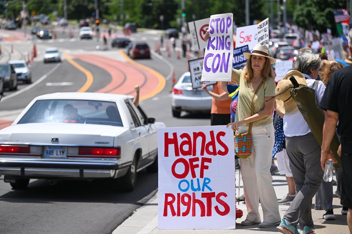 Protesters demonstrate during the “No Kings” rally Saturday, June 14, 2025, at Mill Creek Park in Kansas City.