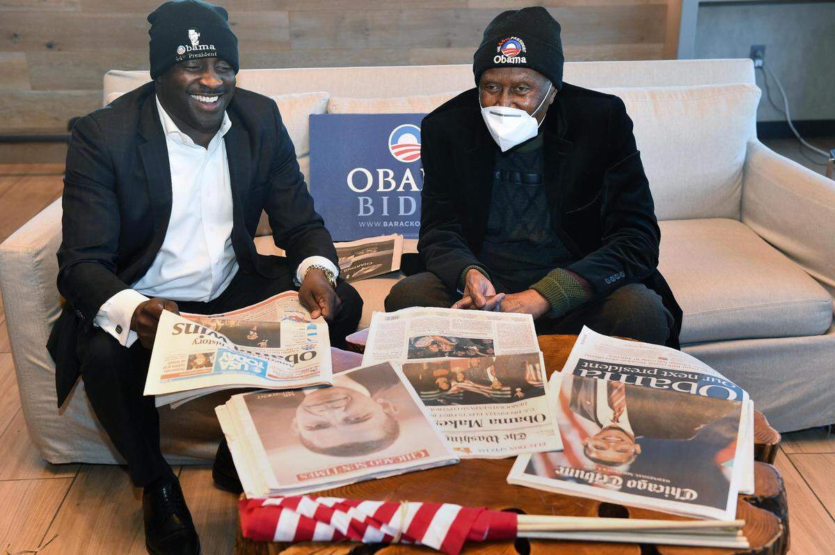 Wearing hats they purchased in Washington, D.C., Jermaine Reed, left, and Alvin Brooks shared a laugh as they reminisced over their trip to the nation’s capital in 2009 to watch the inauguration of President Barack Obama, America’s first Black president. Reed is a longtime friend and protege of Brooks.