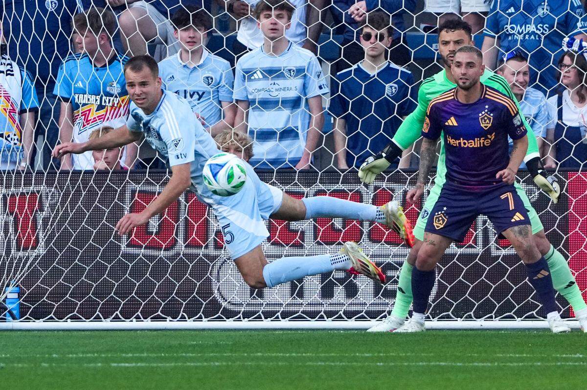 Sporting Kansas City defender Jansen Miller dives to block a shot on goal as L.A. Galaxy midfielder Diego Fagundez looks on, with KC keeper John Pulskamp behind him, during a Sunday, May 4, 2025 Major League Soccer match at Children’s Mercy Park in Kansas City, Kansas.