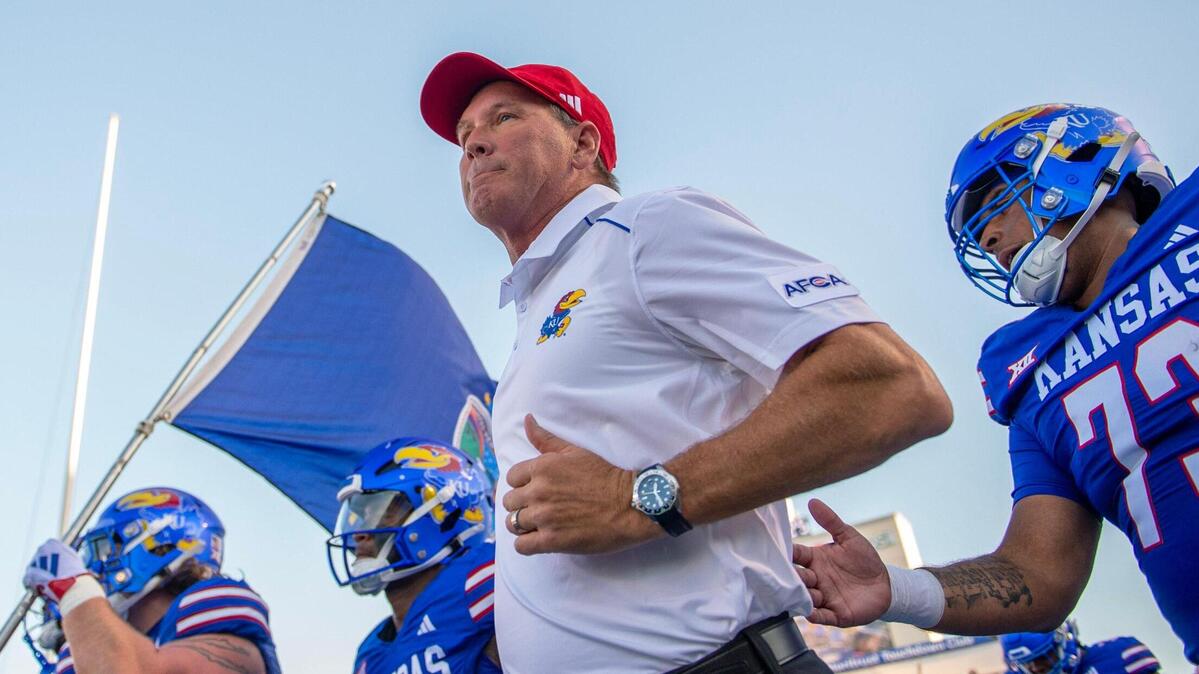 Kansas Jayhawks head coach Lance Leipold runs on the field with players during the season-opening game against the Missouri State Bears at David Booth Kansas Memorial Stadium on Friday, Sept. 1, 2023, in Lawrence, Kan.