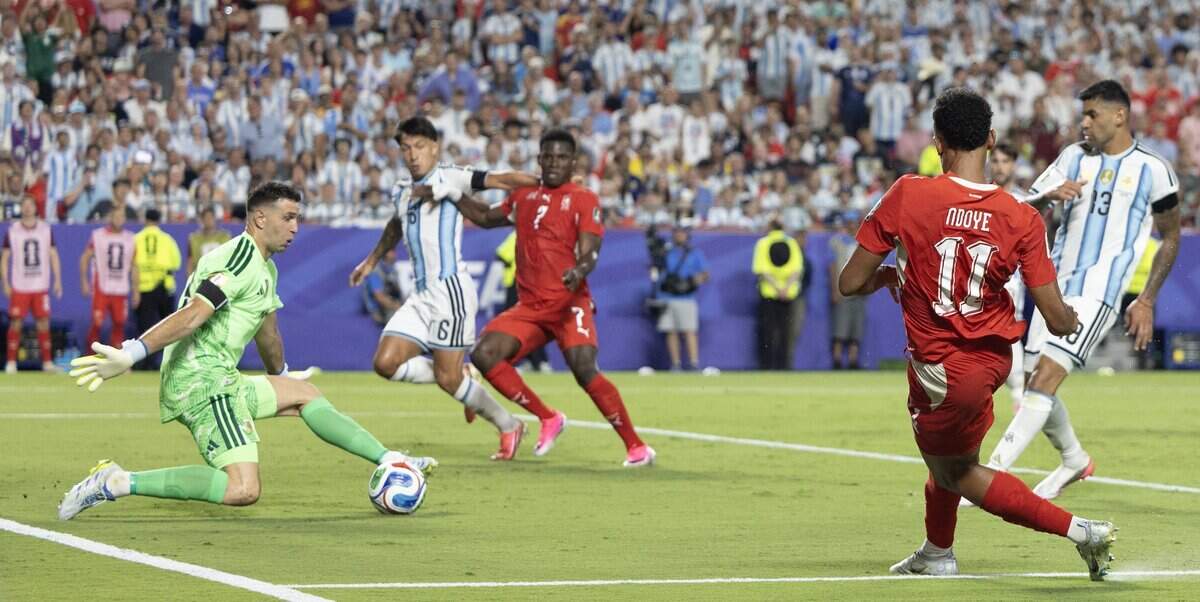 Switzerland forward Dan Ndoye (11) scores against Argentina goalkeeper Emiliano Martínez (23) during the FIFA World Cup quarterfinal match at Kansas City (Arrowhead) Stadium in Kansas City on Saturday, July 11, 2026.
