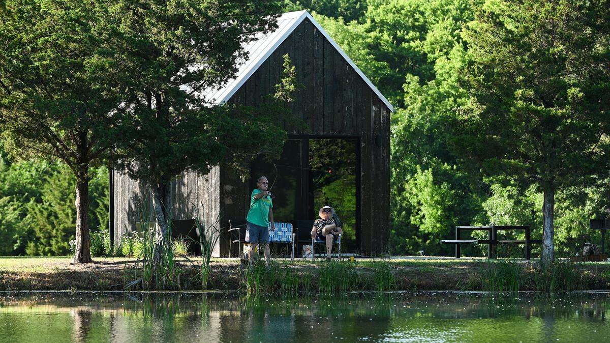 Terry and Janis Jolin of Overland Park fish and sip on rum and cokes at Base Camp, three modern cabins opened in 2020 as part of A Bolder Humboldt’s push to revitalize the town.
