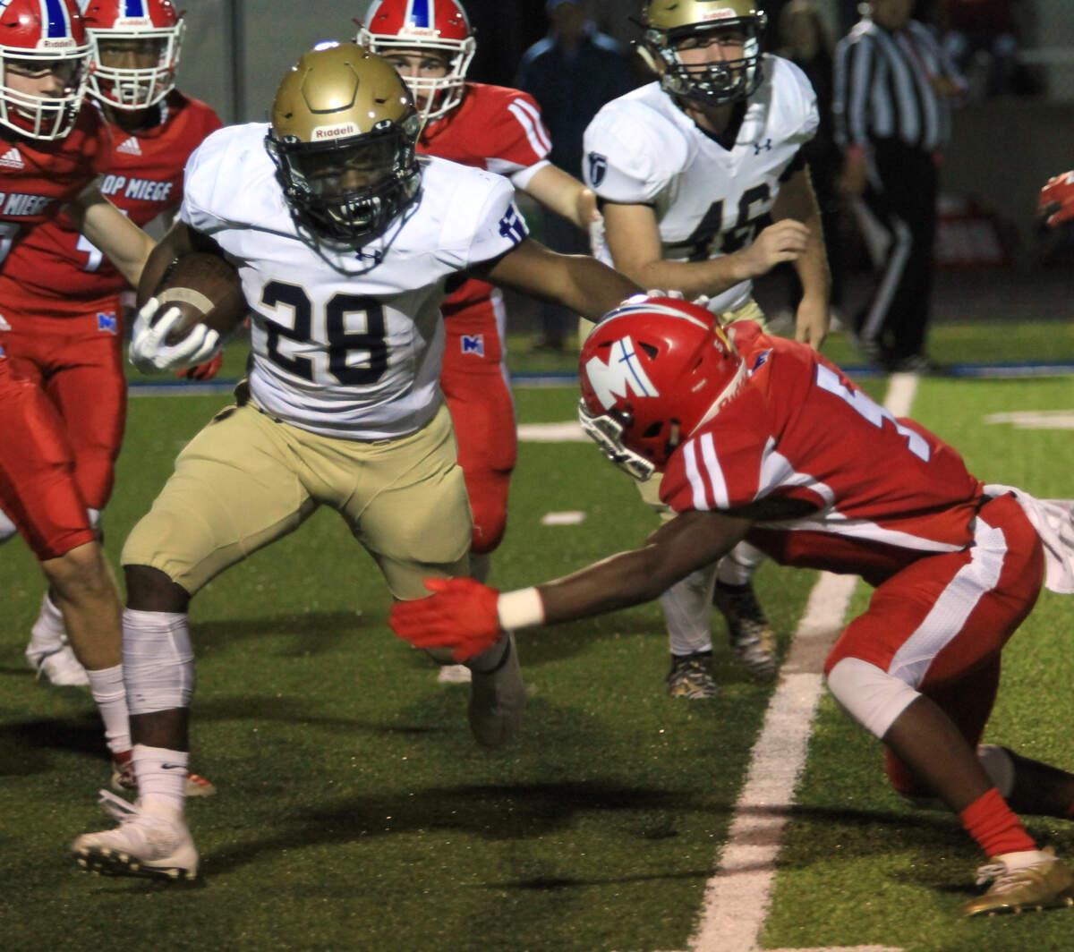 St. Thomas Aquinas’ Tank Young tried to work his way through the Bishop Miege defense on a kickoff return Friday night at Dixon Doll Stadium.