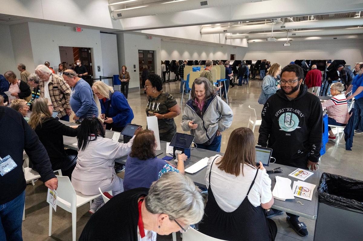 Election workers, left, assisted Johnson County residents who arrived for the first day of in-person advance voting for the 2024 General Election at The Arts and Heritage Center on Saturday, October 19, 2024, in Overland Park.