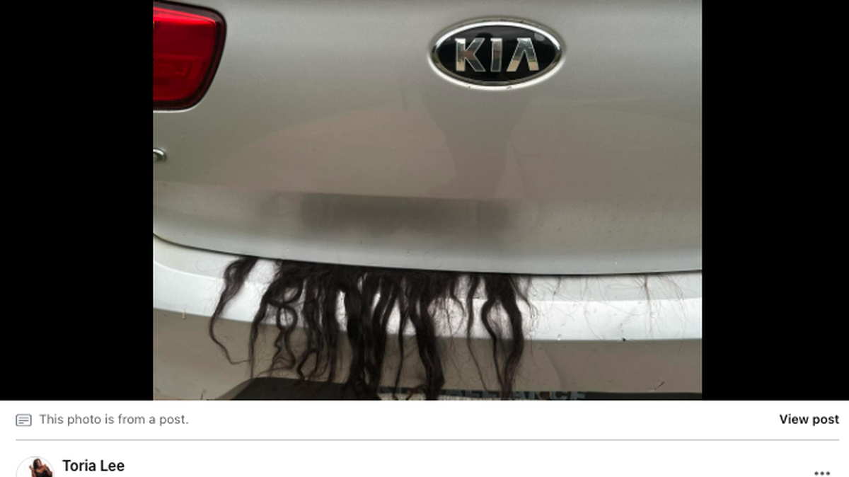 A 911 call was made after hair from a wig protruded out of the trunk of a woman’s vehicle.