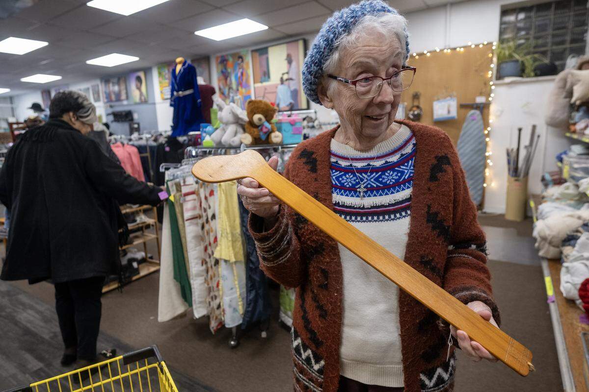Sister Francis Voivedich, a volunteer at Troost39, a thrift store, displays a vintage sock stretcher priced at $1 on Thursday, Jan. 15 2026, in Kansas City. The item was seen online priced at $99.