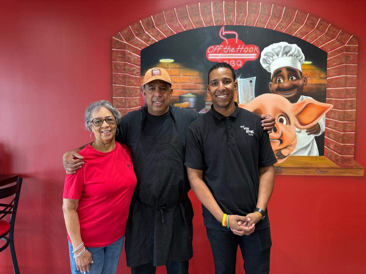 Judy Jones, Wardell Hooks Jr., and Martell Hooks serve barbecue together. Martell says it’s a dream come true.