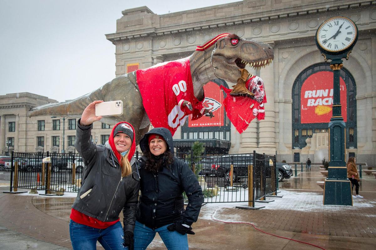 Chiefs fans Jennifer Bigler, left, and Jessica Suarez of Gardner, Kansas, braved the cold and snow for a selfie with a 26-foot-tall T-Rex complete with a Chiefs jersey and a mouthful of Buccaneer at Union Station on Saturday, Feb. 6, 2021. The Chiefs will face Tampa Bay Buccaneers on Sunday in the Super Bowl.