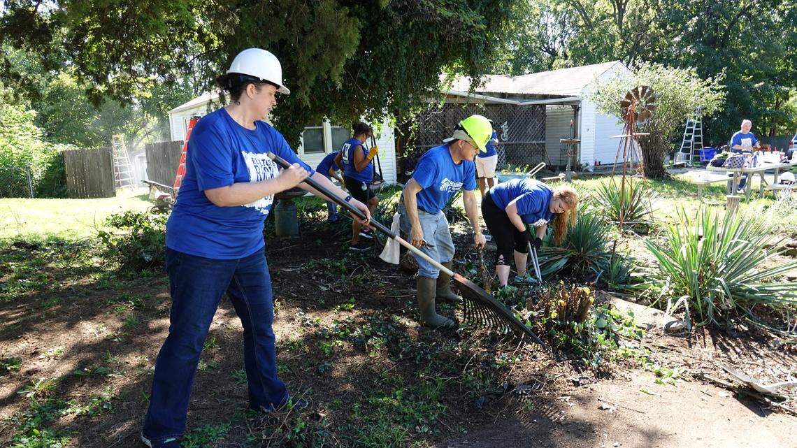 Volunteers work to provide free exterior maintenance, such as painting or landscaping, to residents of downtown Olathe in 2018. The event came as a response to negative feedback from city residents regarding code enforcement.