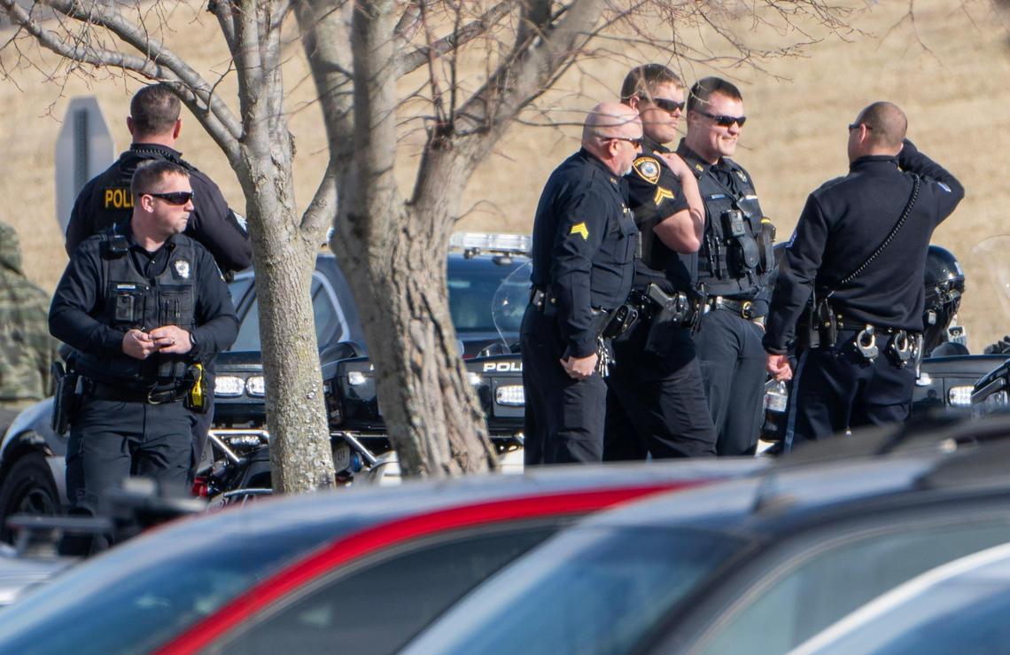 Police officers gather in the parking lot of Centerpoint Medical Center escorting after an Independence police officer who was shot and killed during a call Thursday, Feb. 29, 2024, in the northeast part of the city.