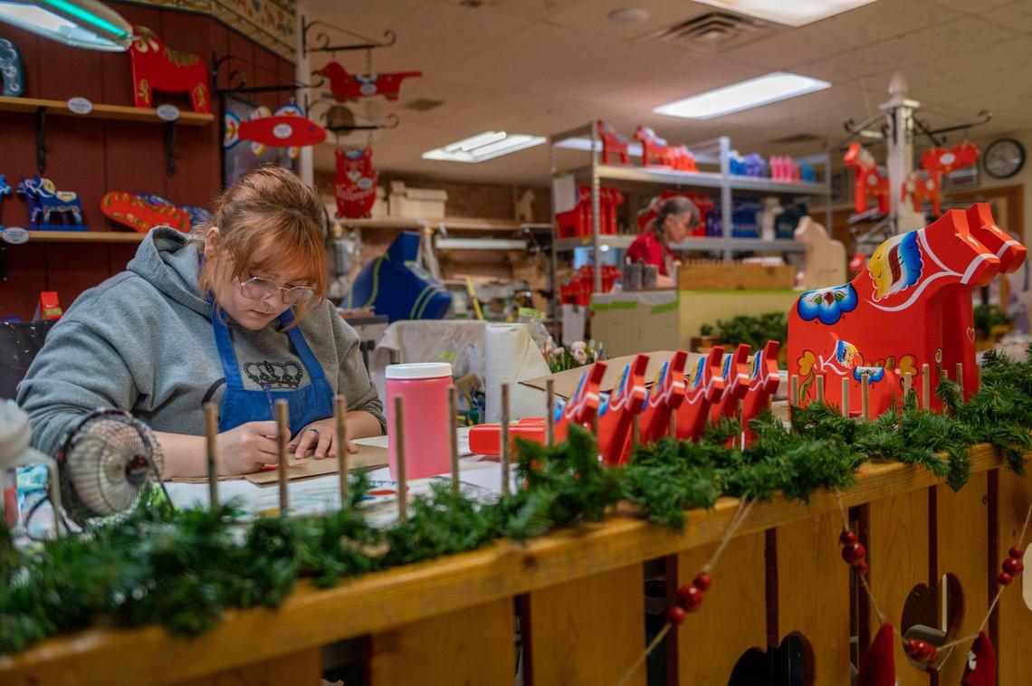 Taryn Stout paints a Dalecarlian horse on a gift bag at the Hemslöjd gift shop in Lindsborg. Stout is a student from Bethany College and is interning at Hemslöjd as an artist.