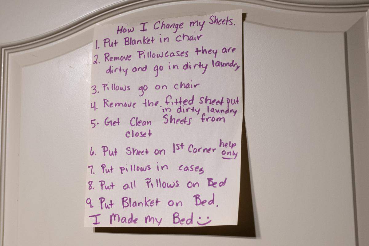 A handwritten list outlining how to change bed sheets is taped to Harrison Long's bedroom door on Tuesday, Feb. 10, 2026, in Parkville.