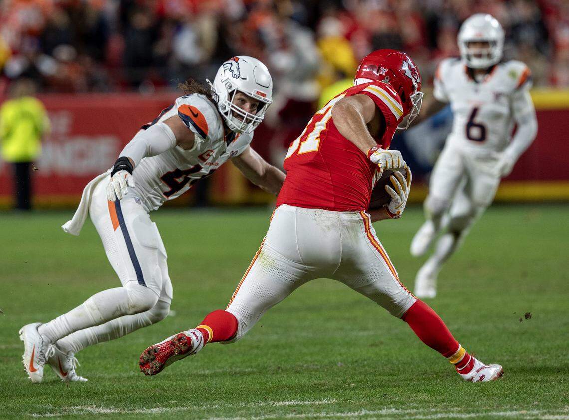 Kansas City Chiefs tight end Travis Kelce (87) runs with a catch against Denver Broncos linebacker Alex Singleton (49) during the second half of the game at GEHA Field at Arrowhead Stadium on Thursday, Dec. 25, 2025, in Kansas City. Denver defeated the Chiefs, 20-13.
