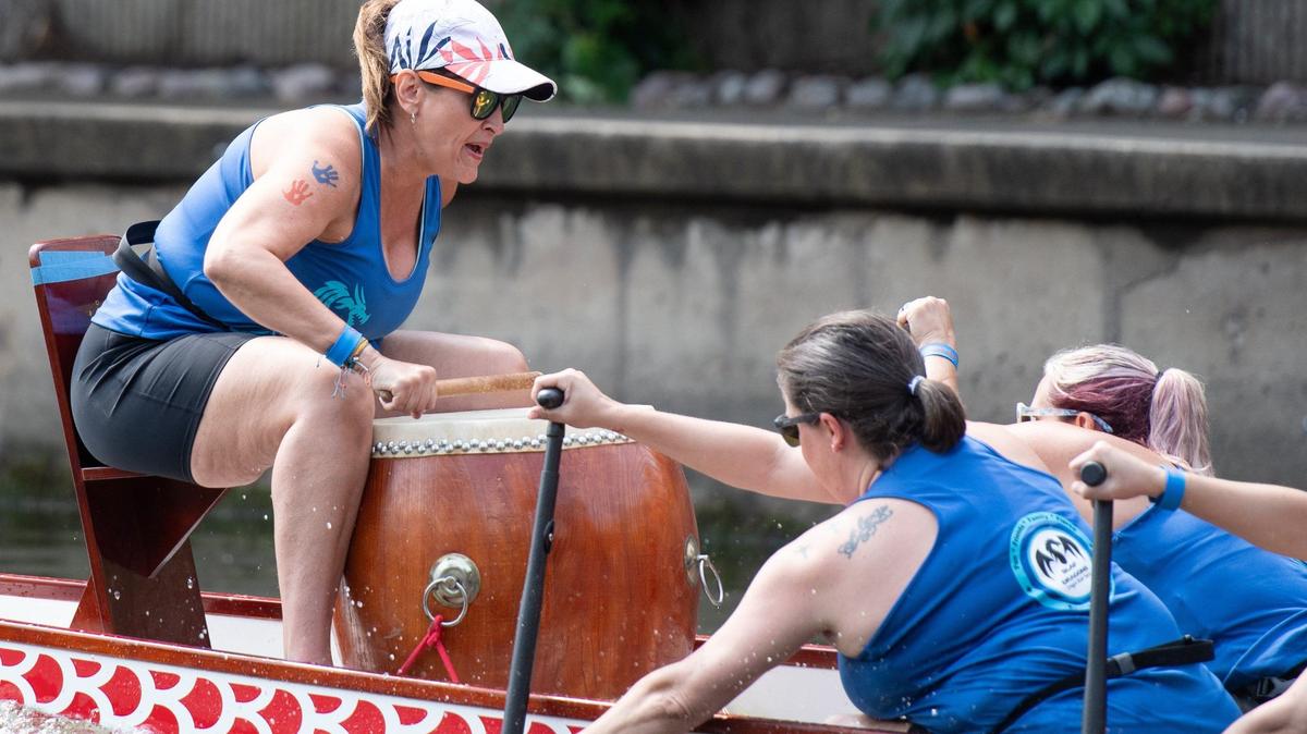 SLAP Dragons President and Coach Kari Rydalch urges her team onward during a dragon boat race on Saturday, June 15, 2024, along Bush Creek in Kansas City.