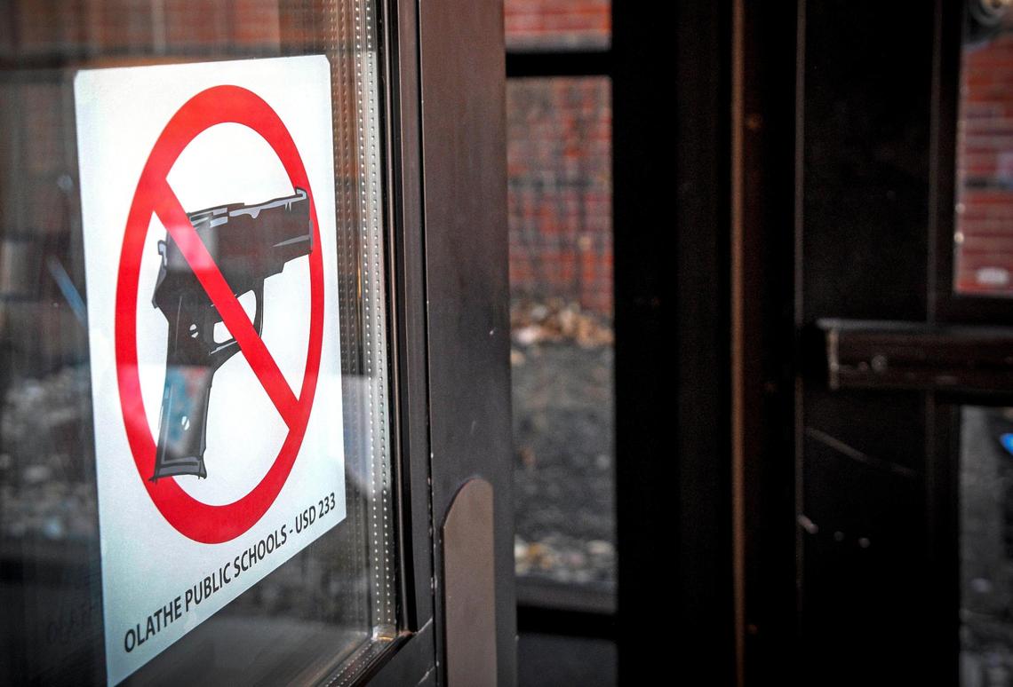 As this sign proclaims, no guns are allowed at Olathe East High School.