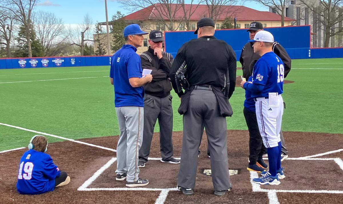 It was a family-friendly scene around home plate before a recent Kansas Jayhawks baseball game at Hoglund Ballpark in Lawrence, Kan. At far right is KU coach Dan Fitzgerald; at far left is his son, Max.