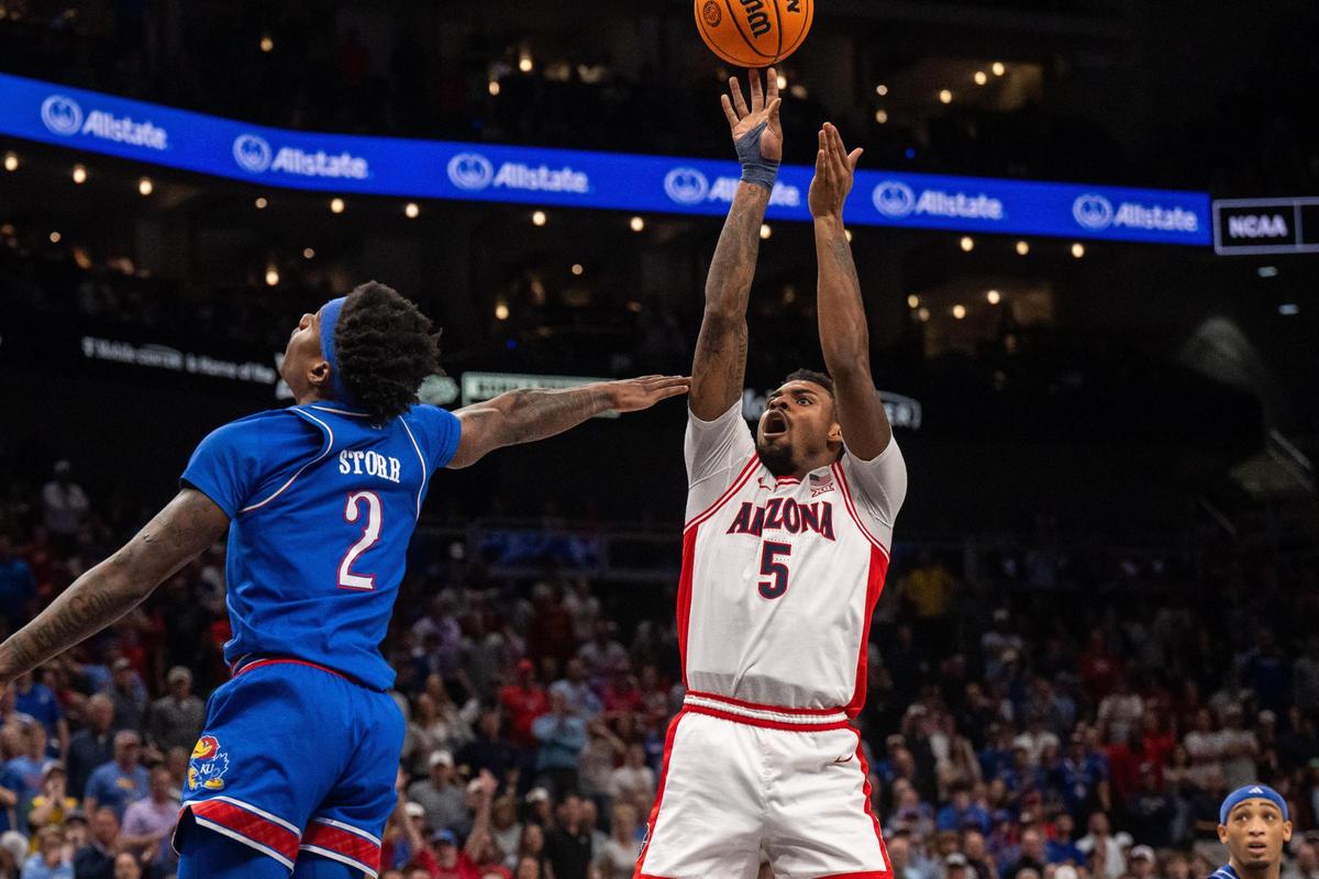 Arizona Wildcats guard KJ Lewis shoots a jumper over Kansas Jayhawks guard AJ Storr in the second half of the Big 12 Championship quarterfinal game on Thursday, March 13, 2025 at T-Mobile Center. The Wildcats won 88-77.