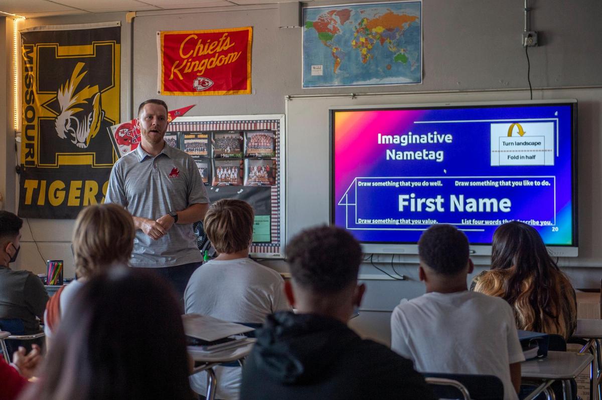 Eighth-grade teacher Caleb Pitts greets his students on the first day of school at Nowlin Middle School in Independence. The district is considering switching to a four-day week.