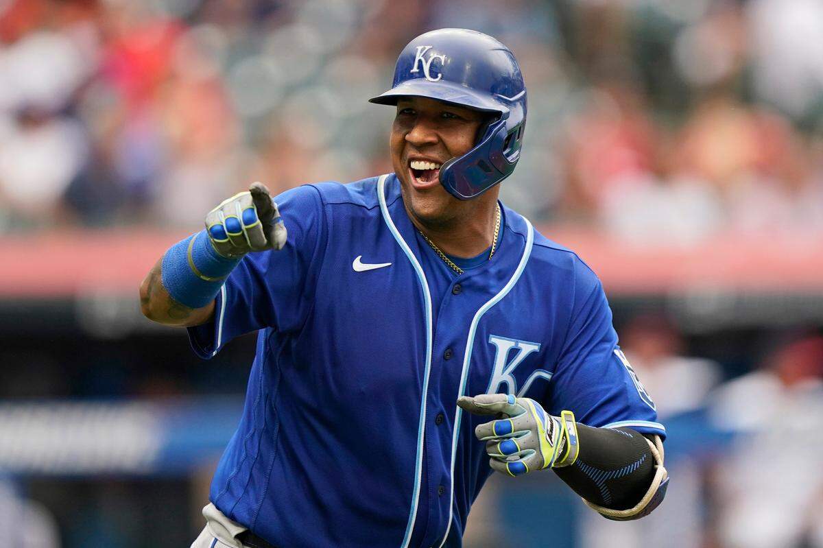 Kansas City Royals’ Salvador Perez smiles and points to the dugout after hitting a two-run home run in the fifth inning in the first baseball game of a doubleheader against the Cleveland Indians, Monday, Sept. 20, 2021, in Cleveland. The home run broke Johnny Bench’s record for the most home runs in a season by a primary catcher. (AP Photo/Tony Dejak)