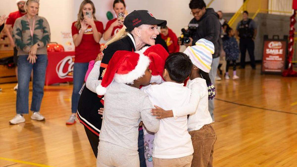 Tammy Reid, wife of Kansas City Chiefs head coach Andy Reid, helped distribute 100 bicycles and helmets to kids at Operation Breakthrough on Thursday. The bikes were donated by Raising Cane’s.