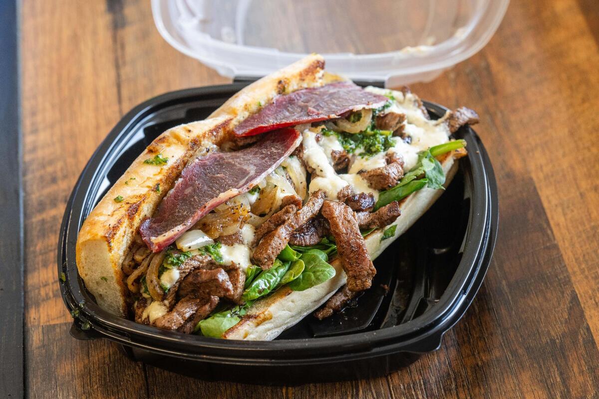 The KC Chiefsteak sandwich at The Upper Cut on Thursday, July 24, 2025 in Liberty. This is one of their ‘Top 10’ sandwiches and has their Akashi Prime steak with peppers, onions, beer cheese, and beef bacon.