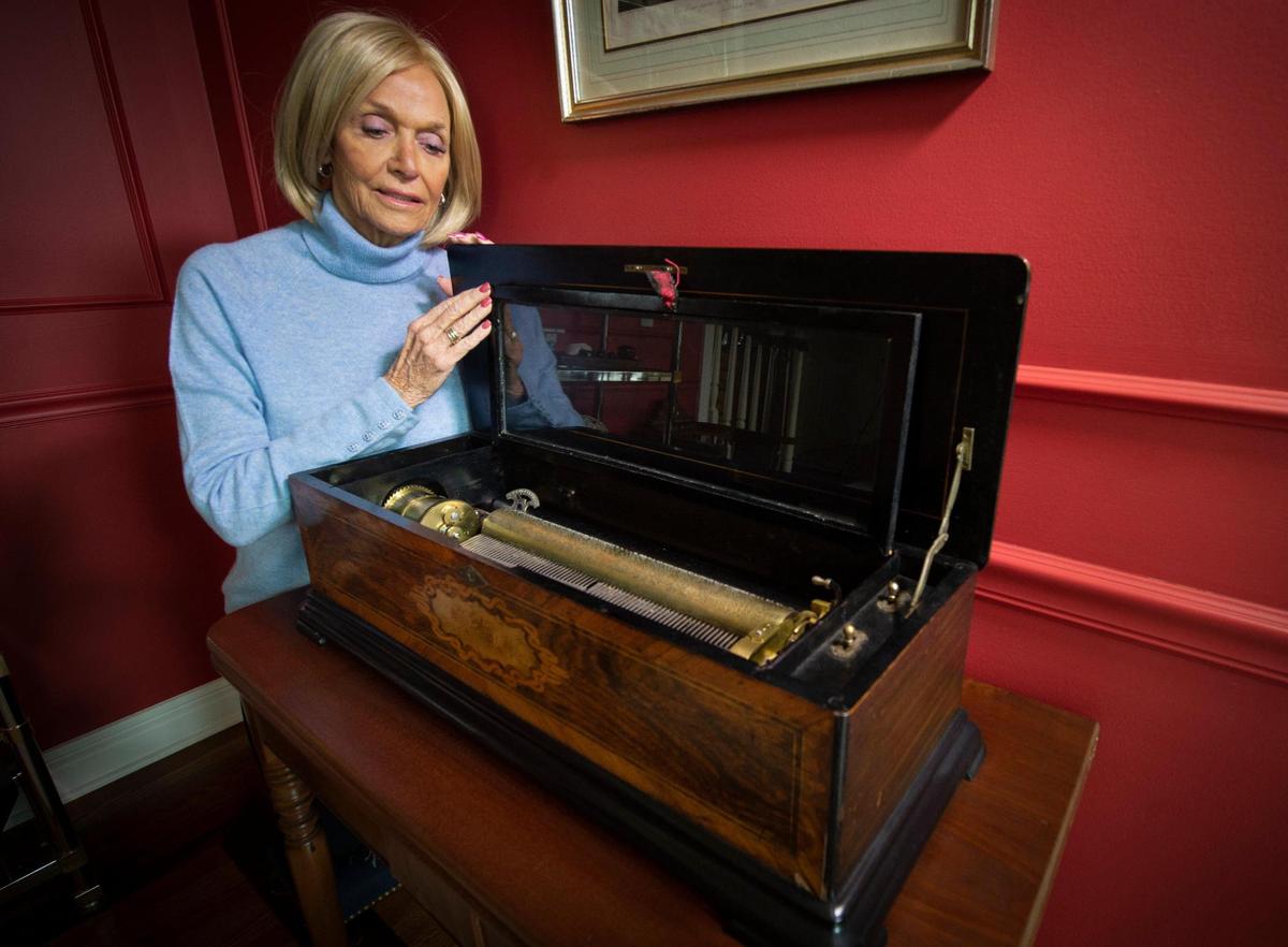 Carol Price looks over the treasured Swiss music box, an antique from The Willows, a maternity home for unwed, pregnant mothers that used to stand at 2929 Main Street in Kansas City. Price was born at and adopted from The Willows, which was founded by her grandparents.