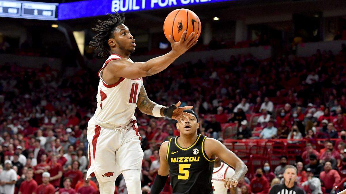 Arkansas guard Chris Lykes (11) drives past Missouri guard Jarron Coleman (5) to score during the first half of an NCAA college basketball game Wednesday, Jan. 12, 2022, in Fayetteville, Ark. (AP Photo/Michael Woods)