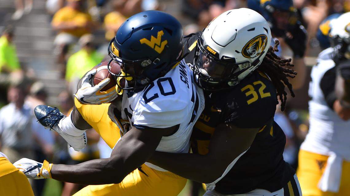 Missouri linebacker Nick Bolton brought down West Virginia running back Alec Sinkfield in fourth-quarter action on Saturday at Faurot Field/Memorial Stadium in Columbia (Sept. 7, 2019)