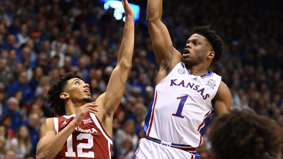 KU’s Joseph Yesufu shoots over OU’s Milos Uzan during the first half of a Big 12 Conference game at Allen Fieldhouse on Jan. 10, 2023.