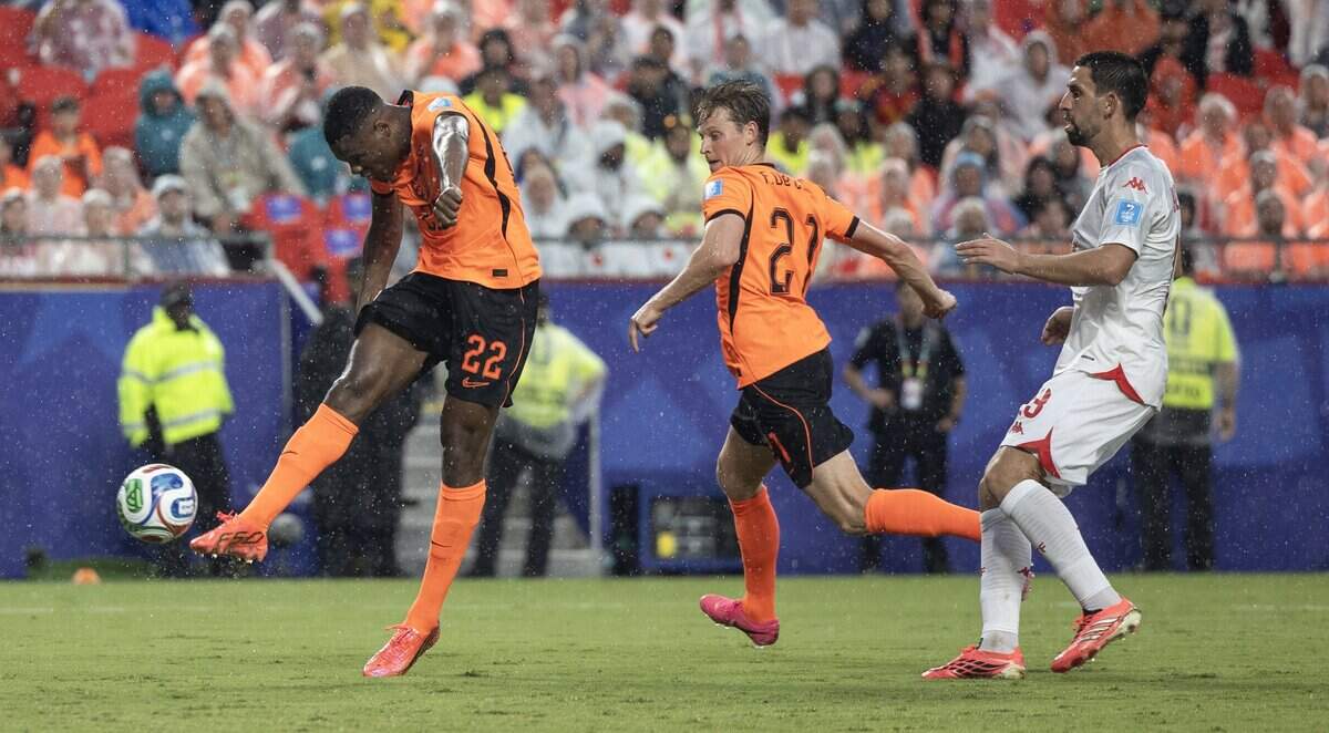 Netherlands defender Denzel Dumfries (22) takes a shot on goal against Tunisia during a FIFA World Cup group-stage soccer match at Kansas City (Arrowhead) Stadium in Kansas City on Thursday, June 25, 2026.