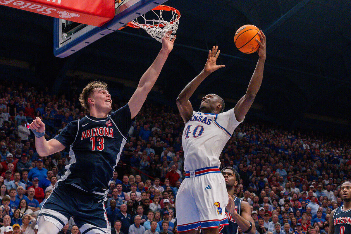 Kansas Jayhawks forward Flory Bidunga (40) goes up for a layup against Arizona Wildcats center Motiejus Krivas (13) in the second half on Monday, February 9, 2026, at Allen Fieldhouse.