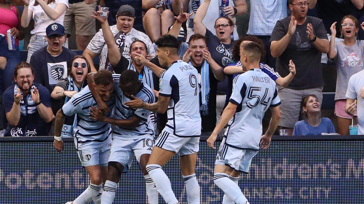 Teammates celebrate with Sporting Kansas City forward Alan Pulido (No. 9) after his Saturday evening goal against the Vancouver Whitecaps at Children’s Mercy Park in Kansas City, Kan.