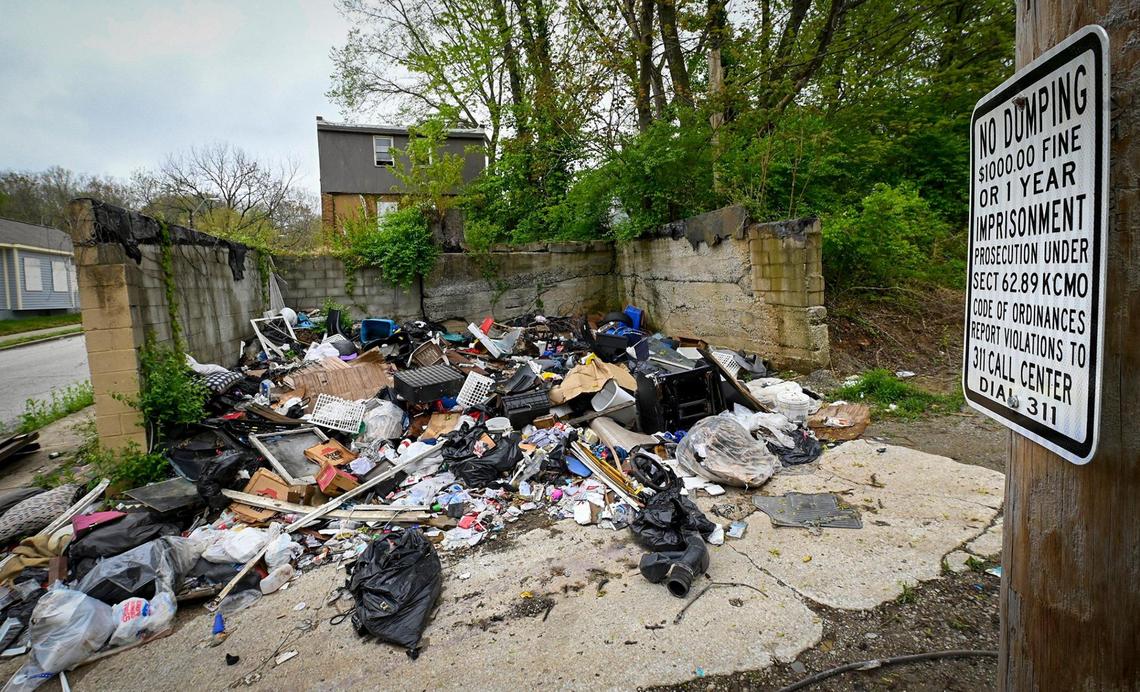 Despite “No Dumping” signs, piles of illegally dumped trash fill an area in a neighborhood near East 24th Street and Monroe Avenue.