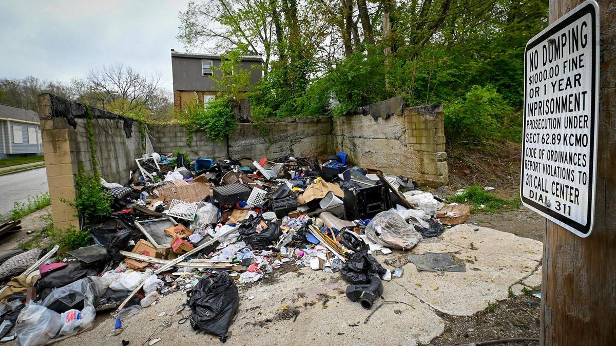 Despite “No Dumping” signs, piles of illegally dumped trash filled an area in a neighborhood near East 24th Street and Monroe Avenue.