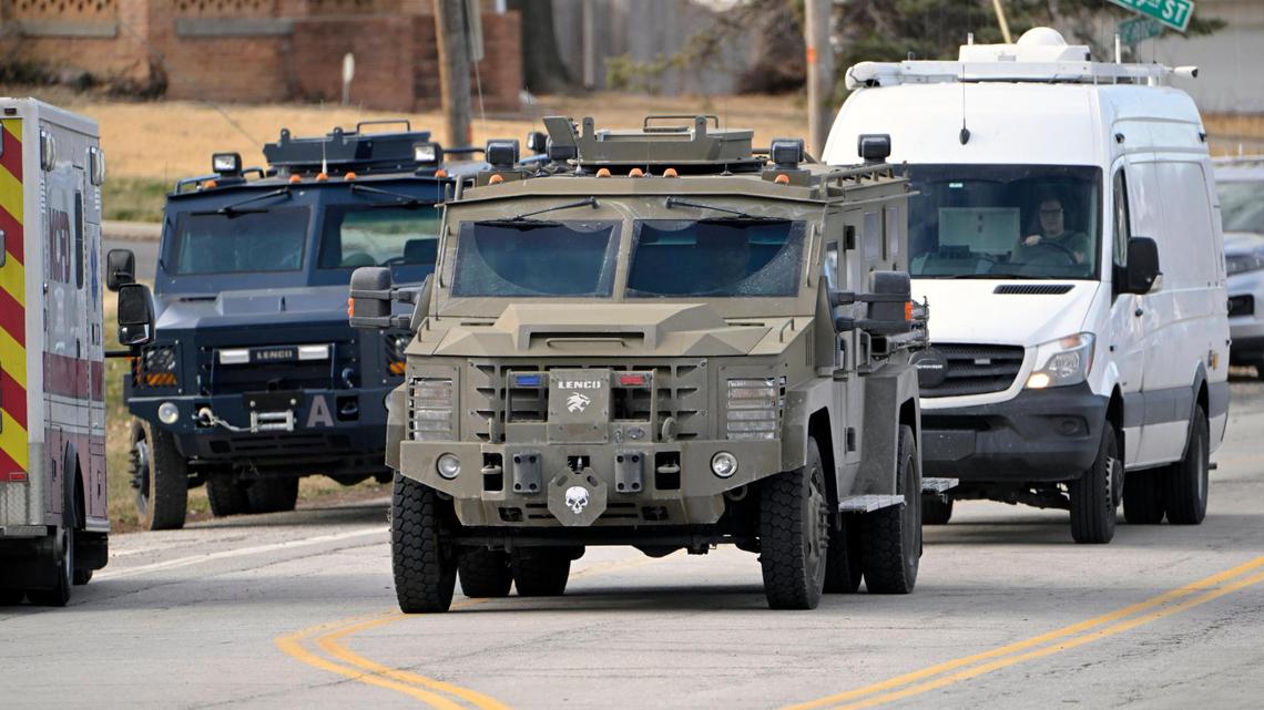 Armored tactical units returned to a police command post at Blue Ridge Boulevard and Westport Road after a close to 18-hour standoff ended after tactical entry was made to a nearby home where there was a deceased man and one unijured woman, who was taken into custody Wednesday afternoon, March 1, 2023, in Kansas City. The standoff began after three Kansas City Police officers were shot Tuesday night while serving a search warrant.