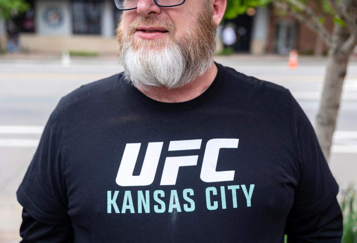 Eric Trease, of Baxter Springs, Kansas, talks about his UFC fandom with a group outside the T-Mobile Center in Kansas City ahead of UFC Fight Night: Machado Garry vs. Prates on Saturday.