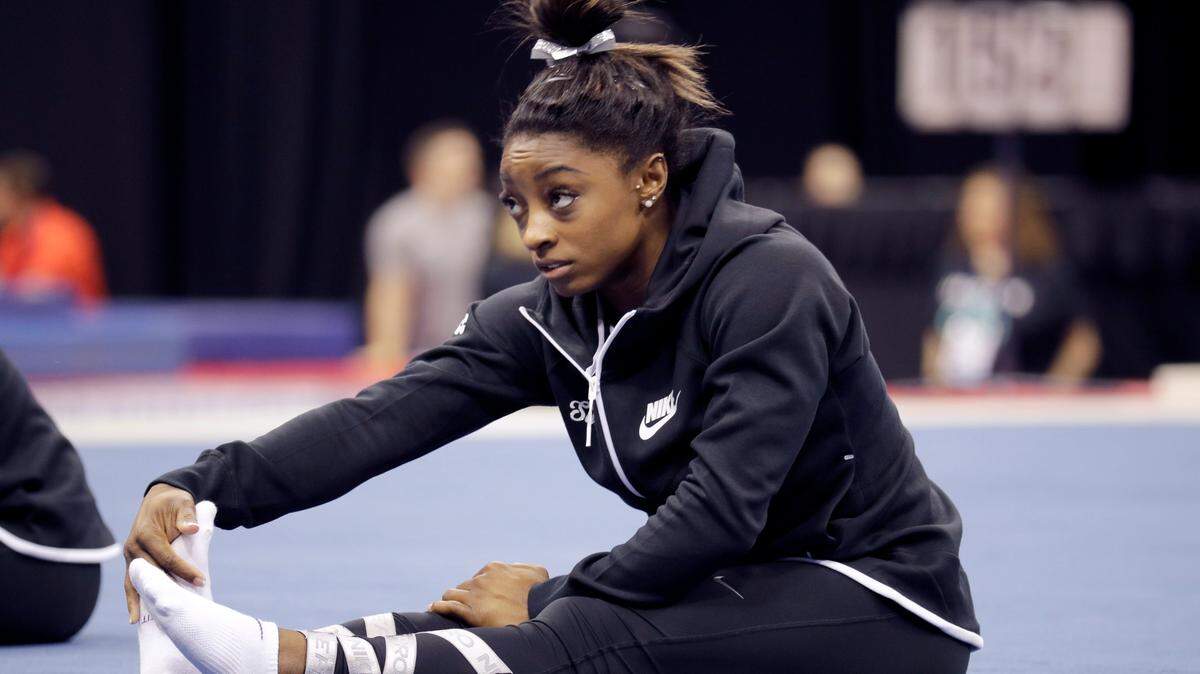 Simone Biles stretches during practice for the U.S. Gymnastics Championships Wednesday in Kansas City.