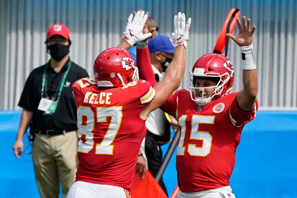 Chiefs quarterback Patrick Mahomes celebrates with Travis Kelce after throwing a touchdown pass to his tight end Sunday in L.A. against the Chargers.