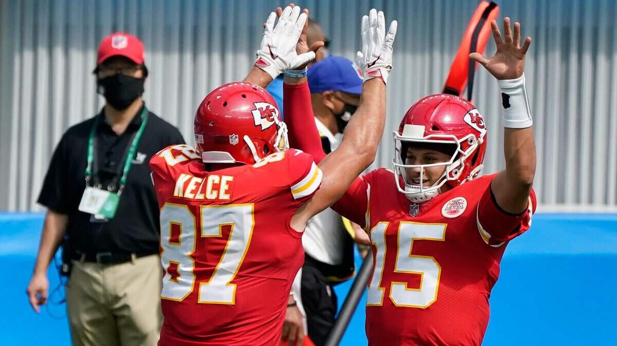 Chiefs quarterback Patrick Mahomes celebrates with Travis Kelce after throwing a touchdown pass to his tight end Sunday in L.A. against the Chargers.